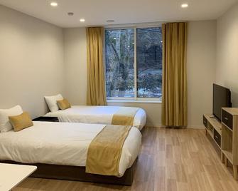 瓦达诺森林酒店及公寓 - 白马村 - 睡房